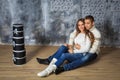 Couple of young people in love, hugging, sitting on the floor and smiling Royalty Free Stock Photo