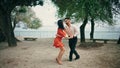 Couple professional dancers dancing in park summer day. Pair performing salsa.