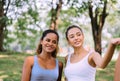 Couple of young sporty woman standing together at public park in the morning,Happy and smiling,Relaxing time
