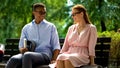 Couple of young students having date, sitting on bench in park, relationship Royalty Free Stock Photo