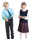 Couple of young students in school uniform reading books together, isolated white background Royalty Free Stock Photo