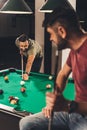 couple of young successful handsome men playing in pool Royalty Free Stock Photo