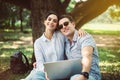 Couple young teen lover sitting and using laptop computer together at park,Romantic and enjoying in moment of happiness time,Happy Royalty Free Stock Photo