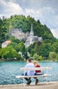 Couple of young tourists in love. Enjoying the panoramic view of the Lake Bled, located in Slovenia, Europe. Royalty Free Stock Photo