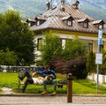 Couple of young tourists resting on a bench in Cortina d\'Ampezzo, Italy