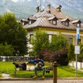 Couple of young tourists resting on a bench in Cortina d\'Ampezzo, Italy