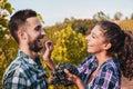 couple of young winemakers picking bunches of grapes in the vineyard