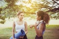 Couple young woman holding yoga mat and talking together at public park,Happy and smiling,Healthy and lifestyle concept