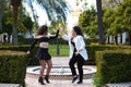 Couple of young women dancing to different types of Latin music and dance. The two girls do different postures dancing outdoors in