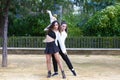 Couple of young women dancing to latin music Bachata, merengue, salsa. The two girls do different postures dancing outdoors in