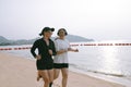 couples asian woman running on sea beach with happiness