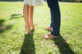 Couples bare feet standing on grass