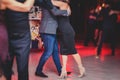 Couples dancing argentinian dance milonga in the ballroom, tango lesson in the red lights, dance festival Royalty Free Stock Photo