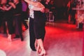 Couples dancing argentinian dance milonga in the ballroom, tango lesson in the red lights, dance festival Royalty Free Stock Photo