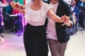 Couples dancing traditional latin argentinian dance milonga in the ballroom, tango salsa bachata kizomba lesson in the red and Royalty Free Stock Photo