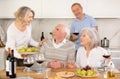 Couples of elderly women and men chatting and drinking Royalty Free Stock Photo