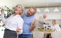 Couple of elderly man and woman dancing in kitchen Royalty Free Stock Photo