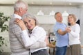 Couple of elderly man and woman dancing in kitchen Royalty Free Stock Photo