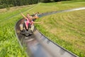 Couples Enjoying Alpine Coaster Luge Royalty Free Stock Photo