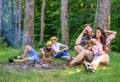 Couples or families having great time relaxing near campfire. Couples spend time outdoors on sunny day. Youth on picnic Royalty Free Stock Photo