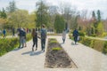 Couples and families walking in park on beautiful spring day. People enjoying warm weather after long winter