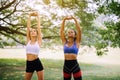 Couple friend girl warming up at outdoor,Sporty young woman doing stretching at public park in the morning Royalty Free Stock Photo