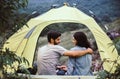 Couple lover hugging together sitting in tent feeling happy and smiling,Enjoying camping Royalty Free Stock Photo