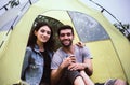 Couple lover looking camera while sitting inside tent together feeling happy and smiling,Enjoying camping Royalty Free Stock Photo