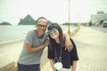 Couples of middle age asian laughing with happiness ,standing beside beach