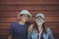 Couples of middle age asian standing against brown wooden background