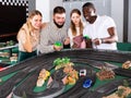 Couples play game slot car racing track Royalty Free Stock Photo