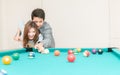 Couples are playing billiards in home