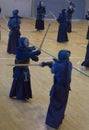 Person practising Kendo, a traditional japanese self defense martial art. With samurai robe, bamboo sword and protective cages