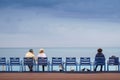 Couples sitting on the bank of the sea feeding pigeons and seagulls Royalty Free Stock Photo