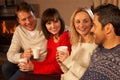 Couples Sitting On Sofa With Hot Drinks Talking Royalty Free Stock Photo
