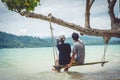 Couples are sitting Swing seaside and looking nature Royalty Free Stock Photo