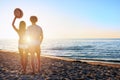 Couples during a sunrise at the beach Royalty Free Stock Photo