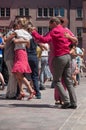 Couples of tango dancers on main place with other dancers at the spring tango festival