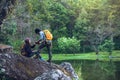 Couple sitting on rocks and taking pictures nature, flowers. at Paphiopedilum orchid conservation center Royalty Free Stock Photo