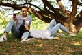 Couples traveling and sleeping relaxation under tree in garden.