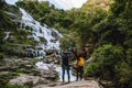Couples traveling to relax, see nature, waterfall mae ya during the holidays at chiangmai in thailand