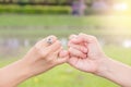 Couples use their little fingers together in the garden