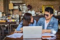 Couples using laptops to work together.