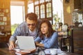 Couples using laptops to work together