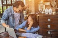 Couples using laptops to work together