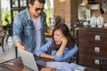 Couples using laptops to work together