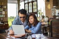 Couples using laptops to work together