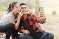 Couples using smartphones to take selfies