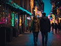 Couples walking hand in hand at night with bright lights