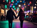 Couples walking hand in hand at night with bright lights